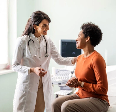 A doctor puts a hand on the shoulder of a patient