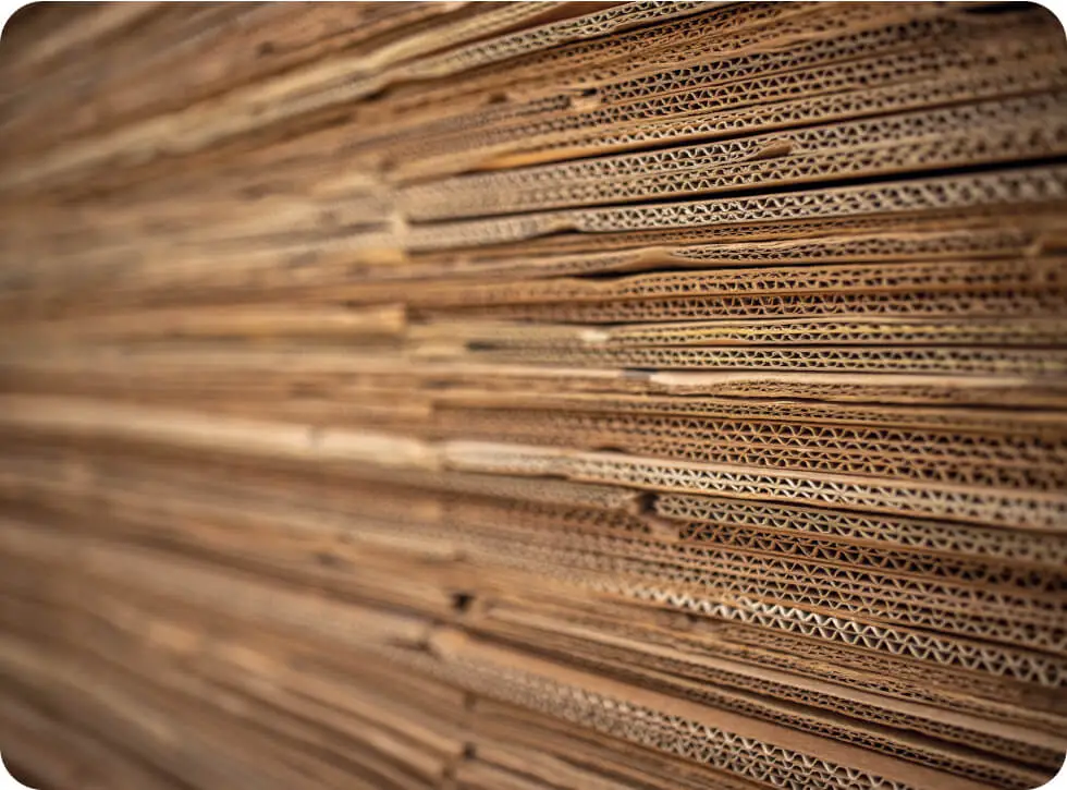 A closeup of a stack of flattened cardboard boxes.