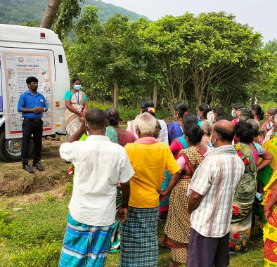 A crowd gathers in India to listen to a speaker