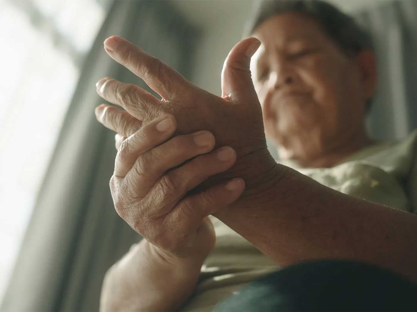 A person clutches their hand.