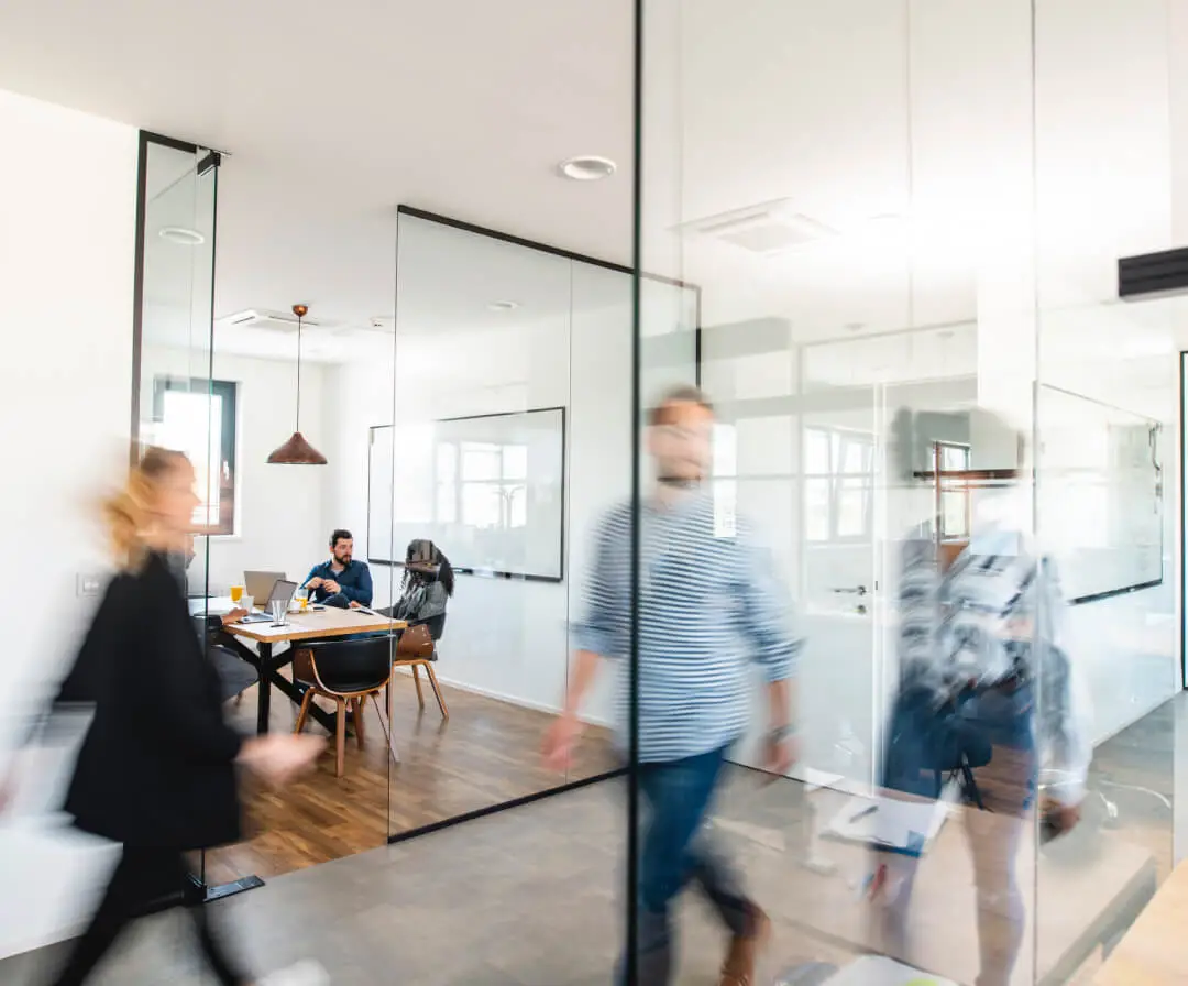 Colleagues walk in an office hallway