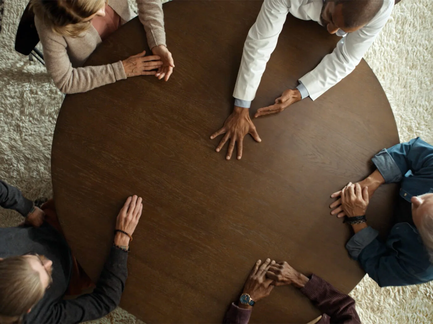 Overhead view of multiple Dupuytren's contracture patients sitting around a table