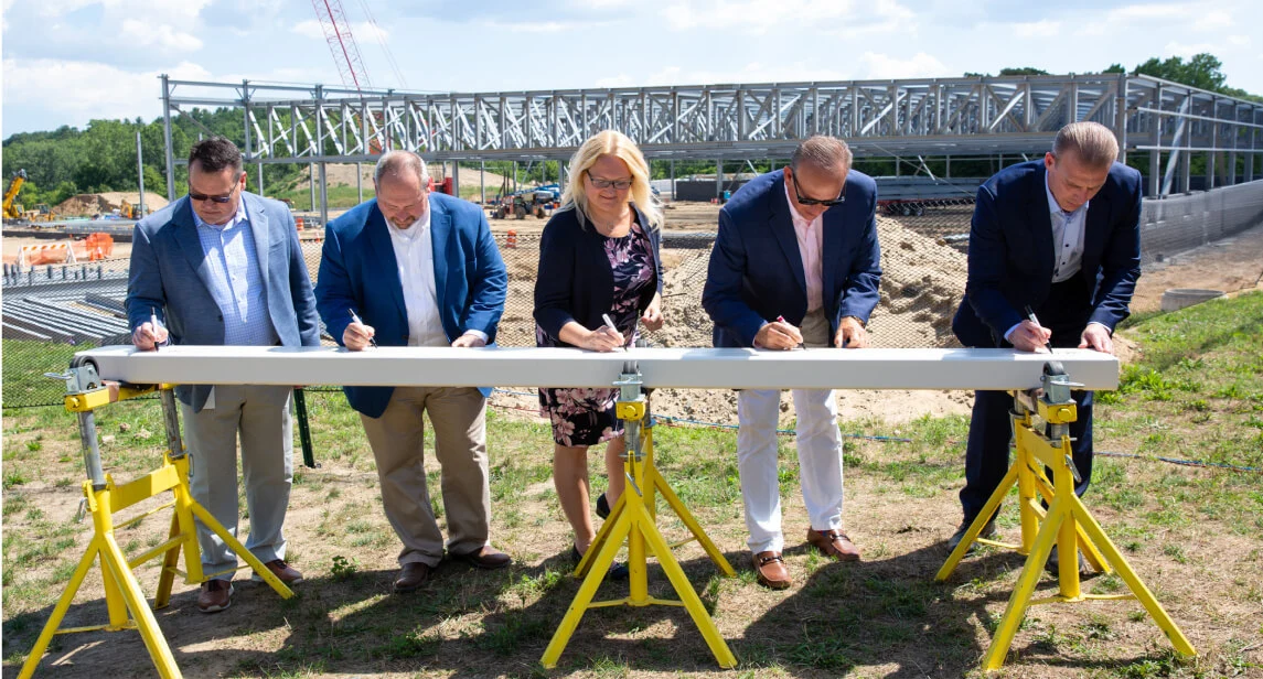 Endo leaders sign a beam that would become part of the Rochester facility expansion, completed in 2023